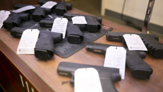 Handguns for sale at High Country Armory on 13th Avenue in La Alma/Lincoln Park. Dec. 21, 2022.