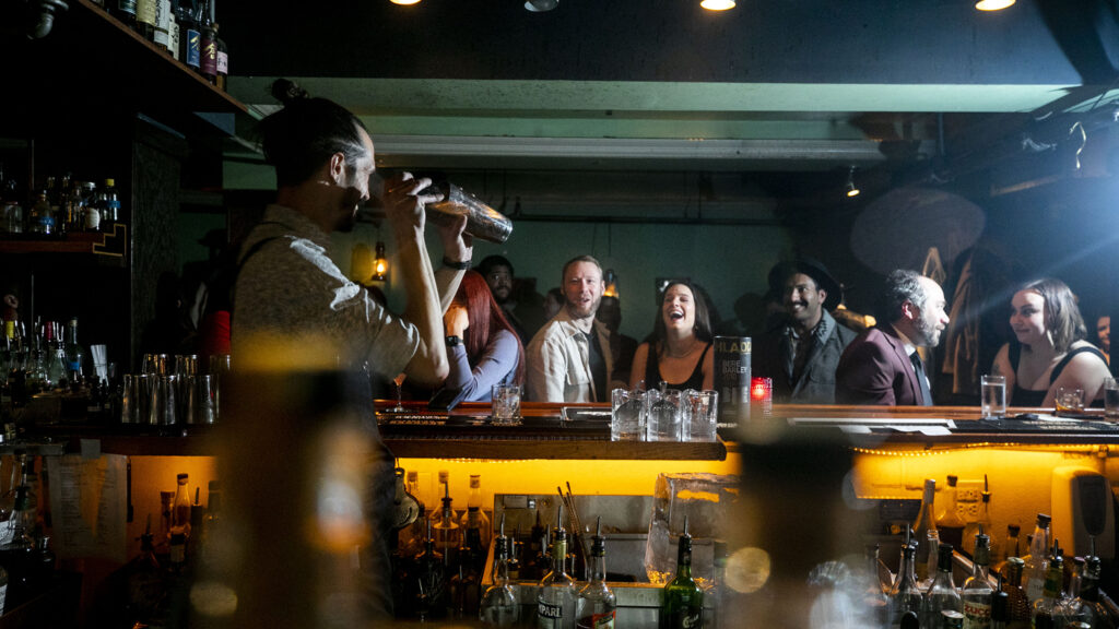 Bartender Addison Blyeth entertains guests during Green Russell's final night in operation. New Year's Eve, Dec. 31, 2022.