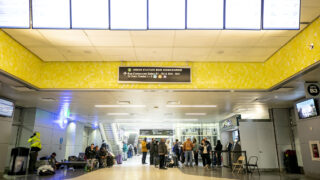Customers line up to purchase Greyhound bus tickets inside Union Station's transit center. Dec. 31, 2022.