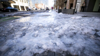 Ice covers part of a sidewalk downtown. Jan. 10, 2023.