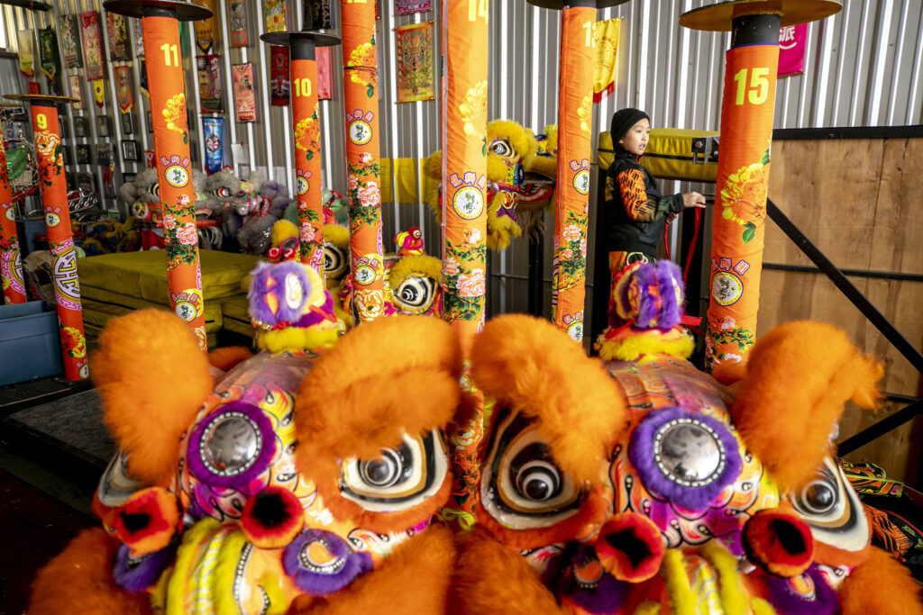 Aspen (9) plays in the north Denver storage unit where Colorado Asian Cultural Heritage Center members keep their gear and practice before dancers head out to a day of performances. Jan. 21, 2023.  Jan. 21, 2023.