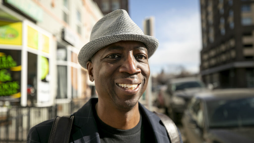 District 9 candidate Darrell Watson stands on 22nd Avenue near TeaLee's Teahouse, one of his favorite spots in Five Points. Feb. 14, 2023.