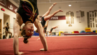 University of Denver women's gymnast Cecilia Cooley warms up before a practice on campus. March 28, 2023.