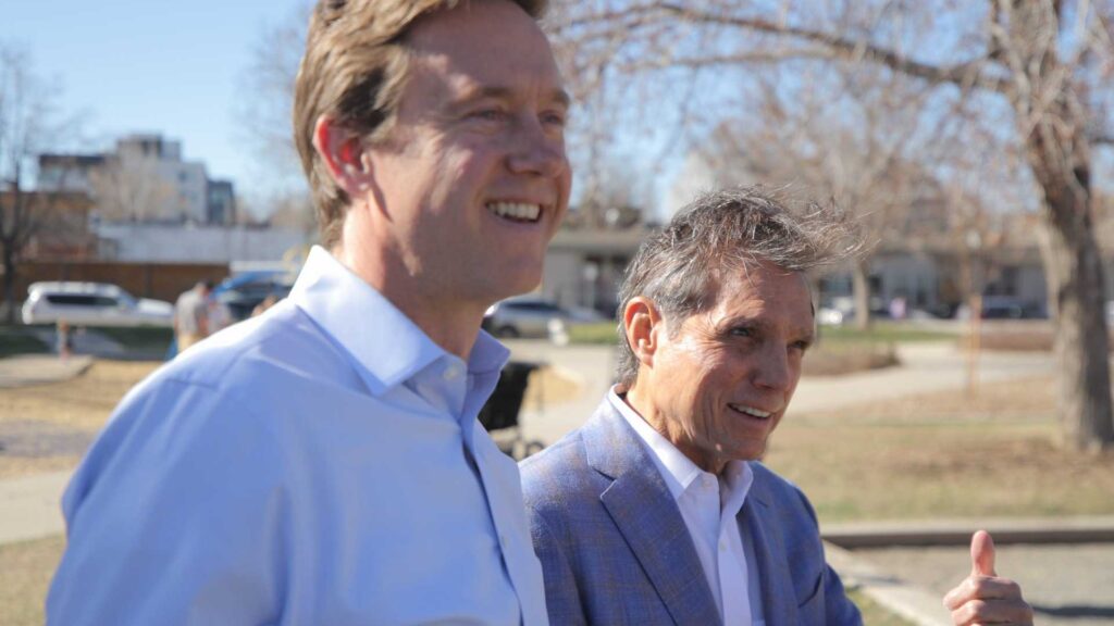 Mayoral candidate Mike Johnston (left) and former Denver mayor Federico Peña at César Chávez Park on April 12, 2023.