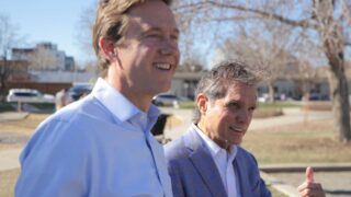 Mayoral candidate Mike Johnston (left) and former Denver mayor Federico Peña at César Chávez Park on April 12, 2023.
