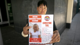 Tanya Lance holds a missing persons poster of her partner, Christine Tail, who was last seen in downtown Denver. June 24, 2023.