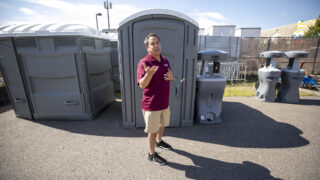 Scott Gilmore, deputy executive director of Denver's Parks and Recreation department, stands in front of a suite of port-a-potties that his crews will modify for use at sidewalk encampments in town. Aug. 8, 2023.