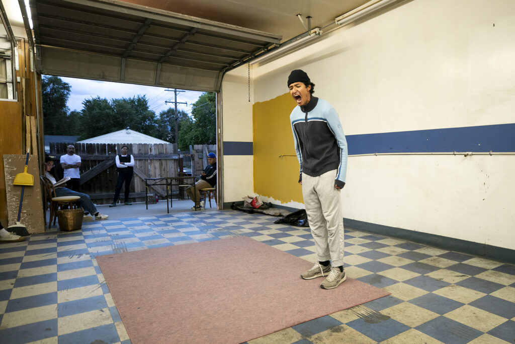 Actor Diego Estrada Bernuy screams as he rehearses a scene for "Cuauhtémoczin," a play by Diego Florez-Arroyo, in Florez-Arroyo's Westwood garage. Sept. 20, 2023.