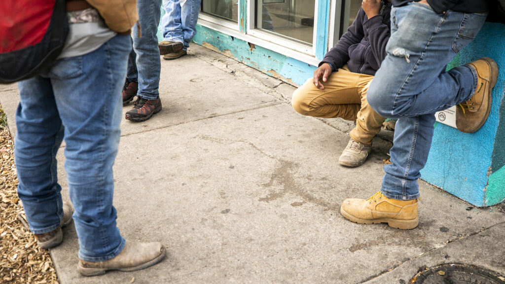 Men wait for the Dayton Street Day Labor Center to open, just off Colfax Avenue in Aurora. Nov. 14, 2023.