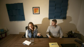 Andrea Chiriboga-Flor (left) and Jason Legg sit in a conference room in the shared Glendale office where their new venture, Justice for People, is housed. Jan. 4, 2024.